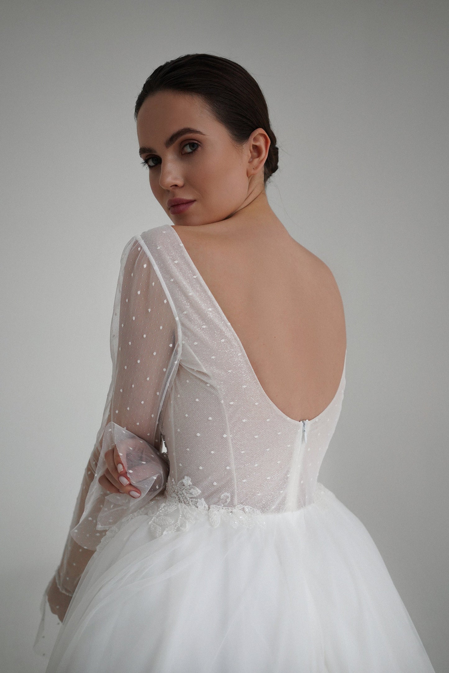 Elegant A-Line Bridal with Deep V-Neck Gown with Sheer Dot Sleeves and Embellished Bodice. Wedding dress with tulle skirt and low open back