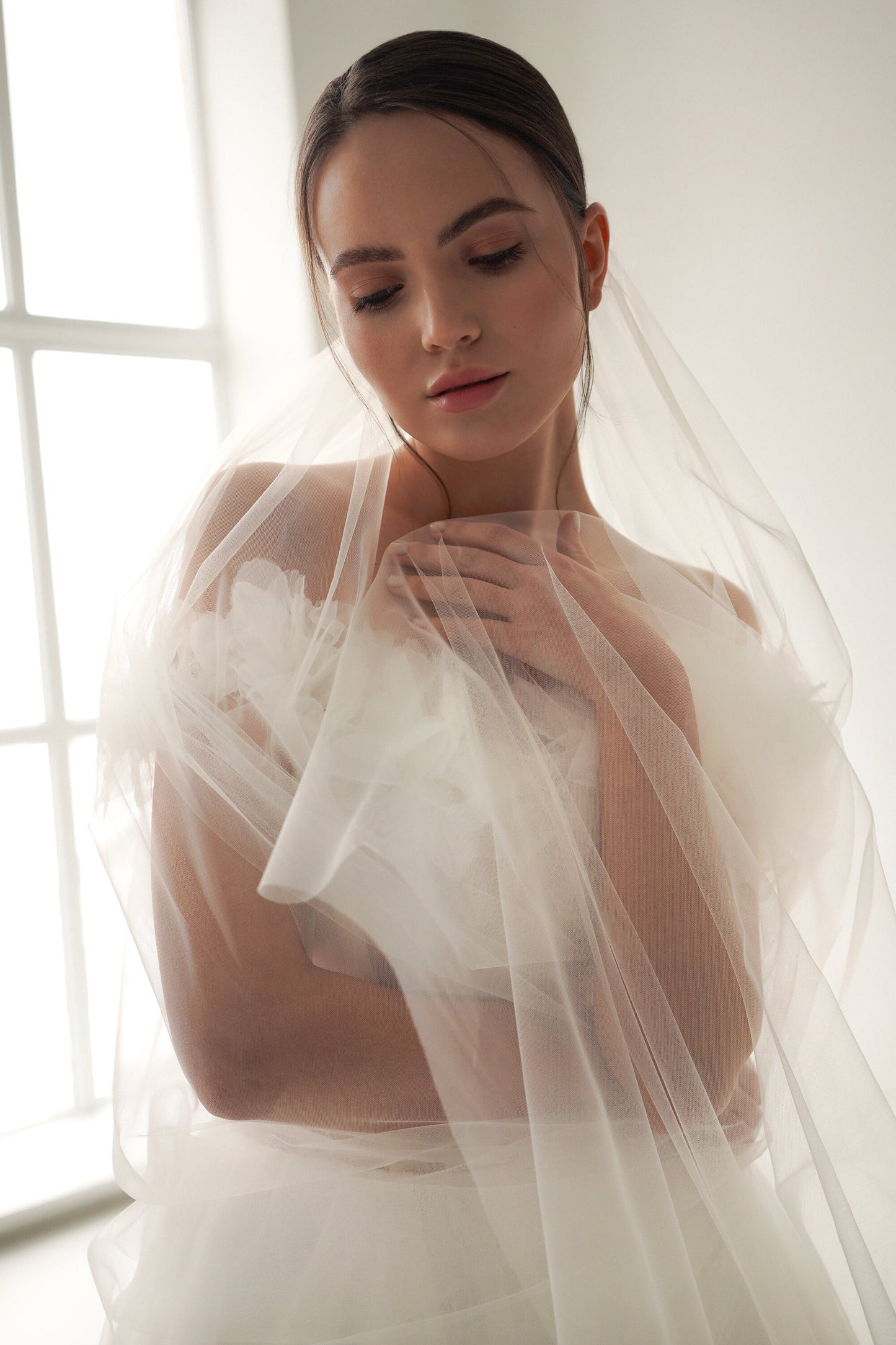 Tulle wedding dress with open shoulders and delicate floral accents , Celestial wedding dress with a textured bodice, Corset wedding dress.